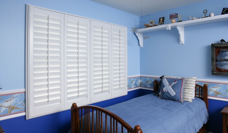 White plantation shutters in blue kids bedroom in Miami 